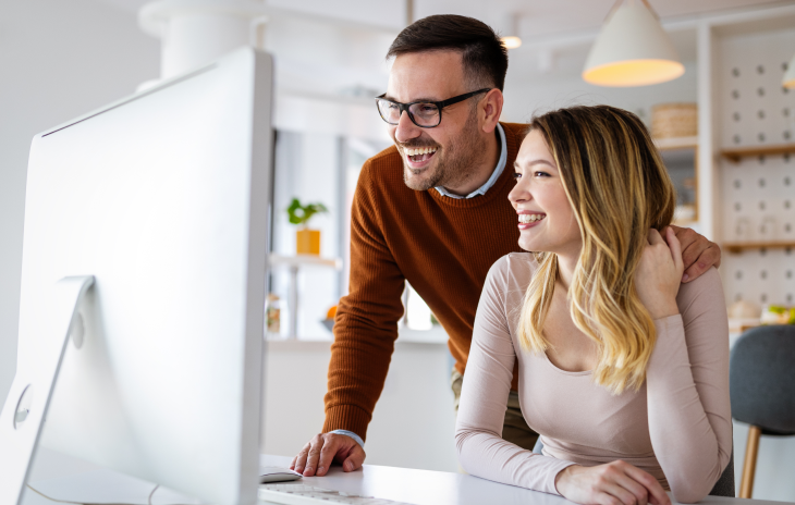 Couple reviewing Moldnosis mold inspection results online on a laptop